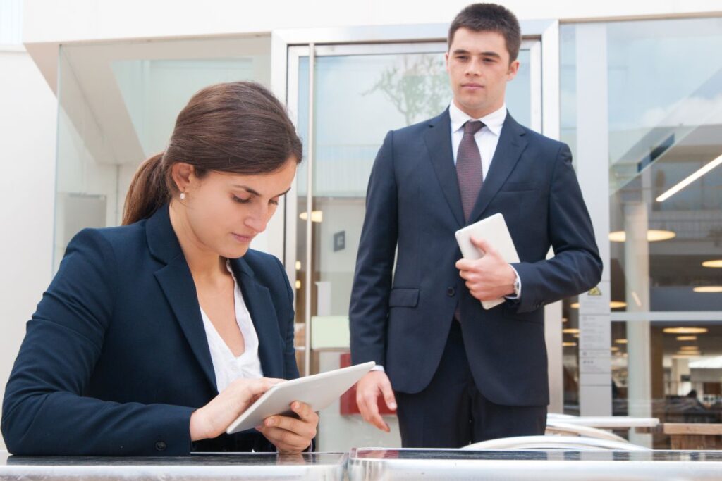Business owner consulting with an experienced business lawyer, reviewing contracts, legal documents, and business plans during a professional office meeting.